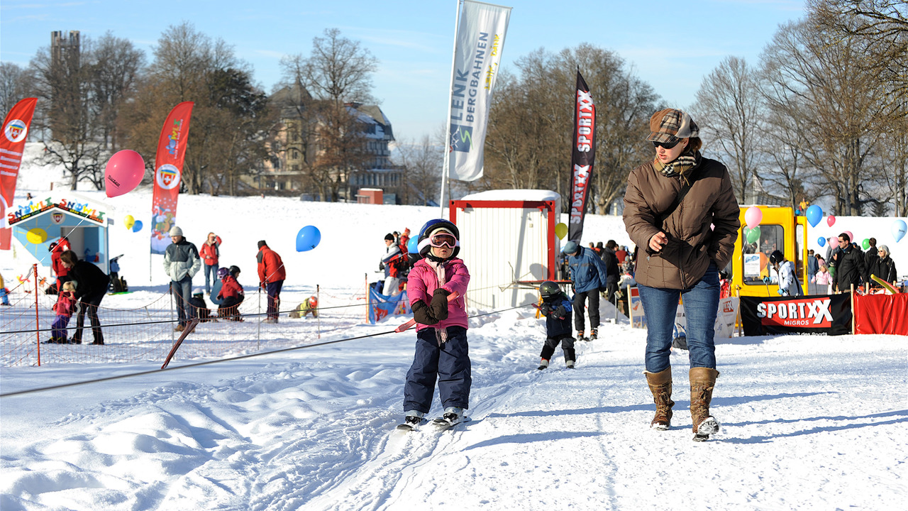 Kinder halten sich an Schlepplift auf Gurten fest
