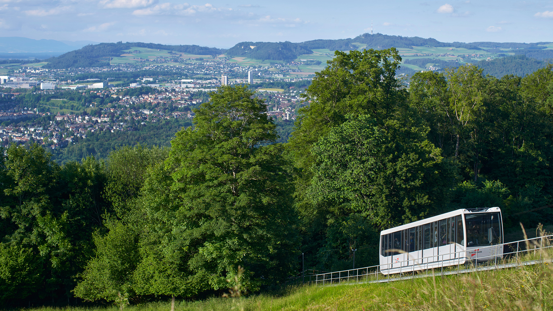 Bahnschiene der Gurtenbahn mit der Aussicht über die Stadt Bern im Hintergrund