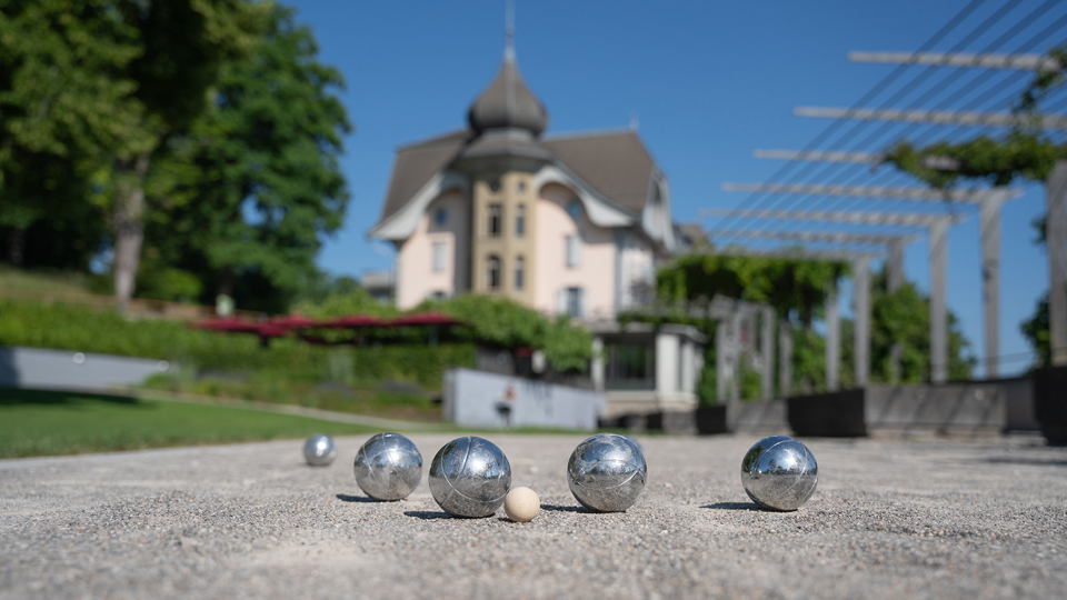 Boule-Kugeln mit dem Kulm-Gebäude im Hintergrund